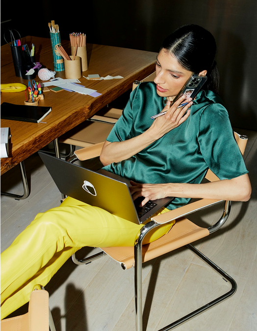 Two people at a conference table giving each other a high-five, showing the collaborative nature of social media strategy.
