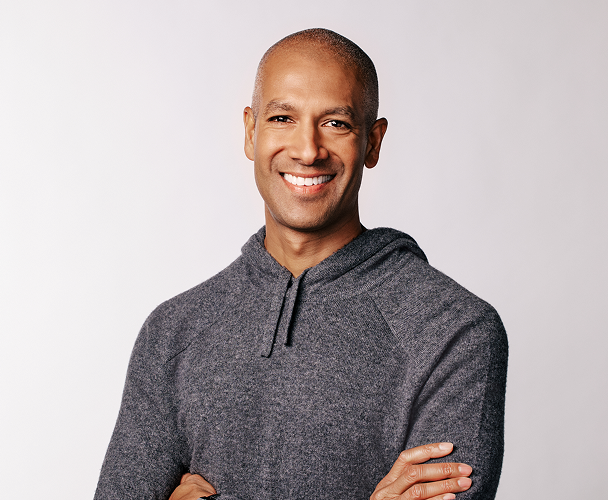 Headshot of Ryan Barretto, Chief Executive Officer, wearing a gray hooded sweatshirt.